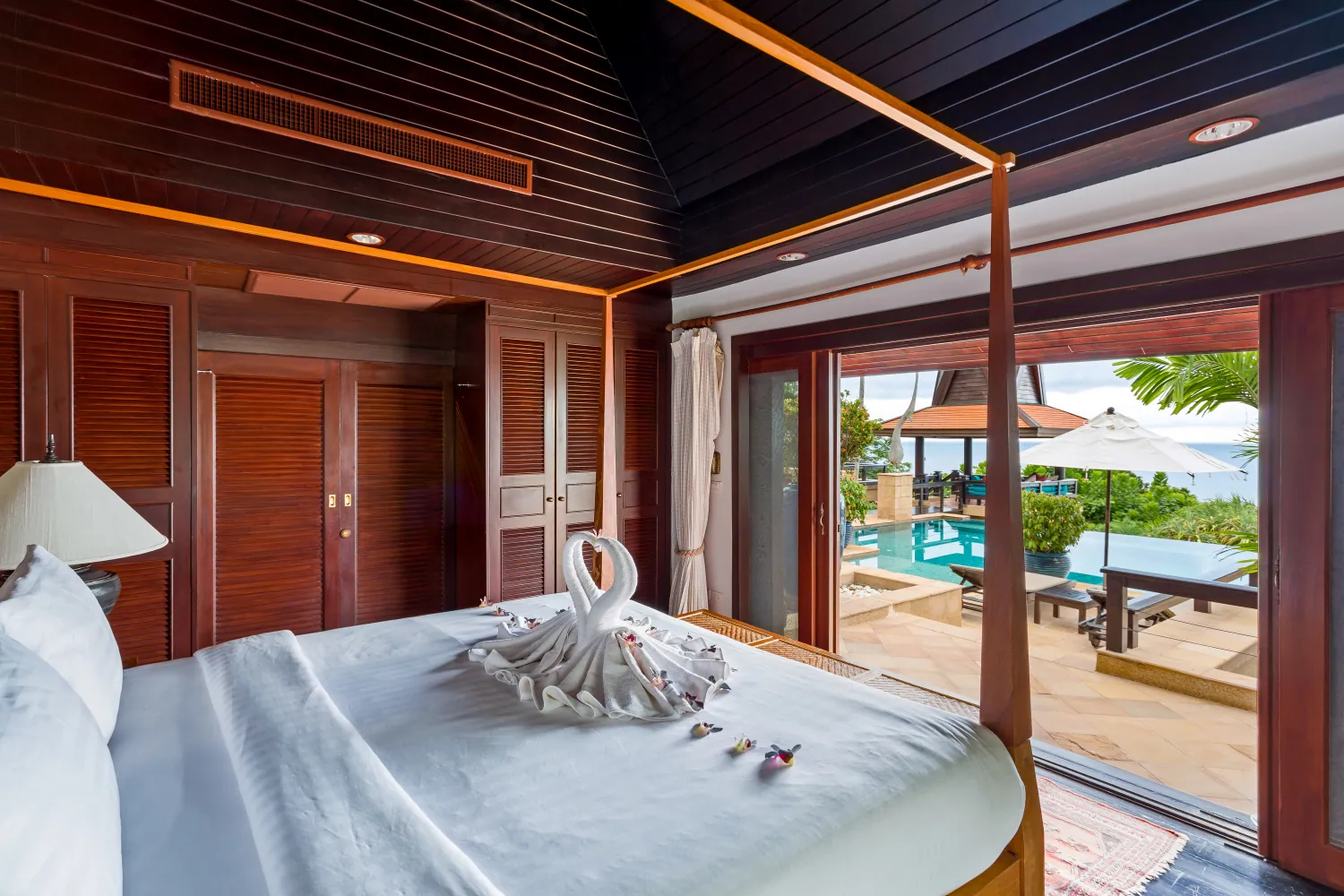 A bedroom looking straight out to the pool and the sea