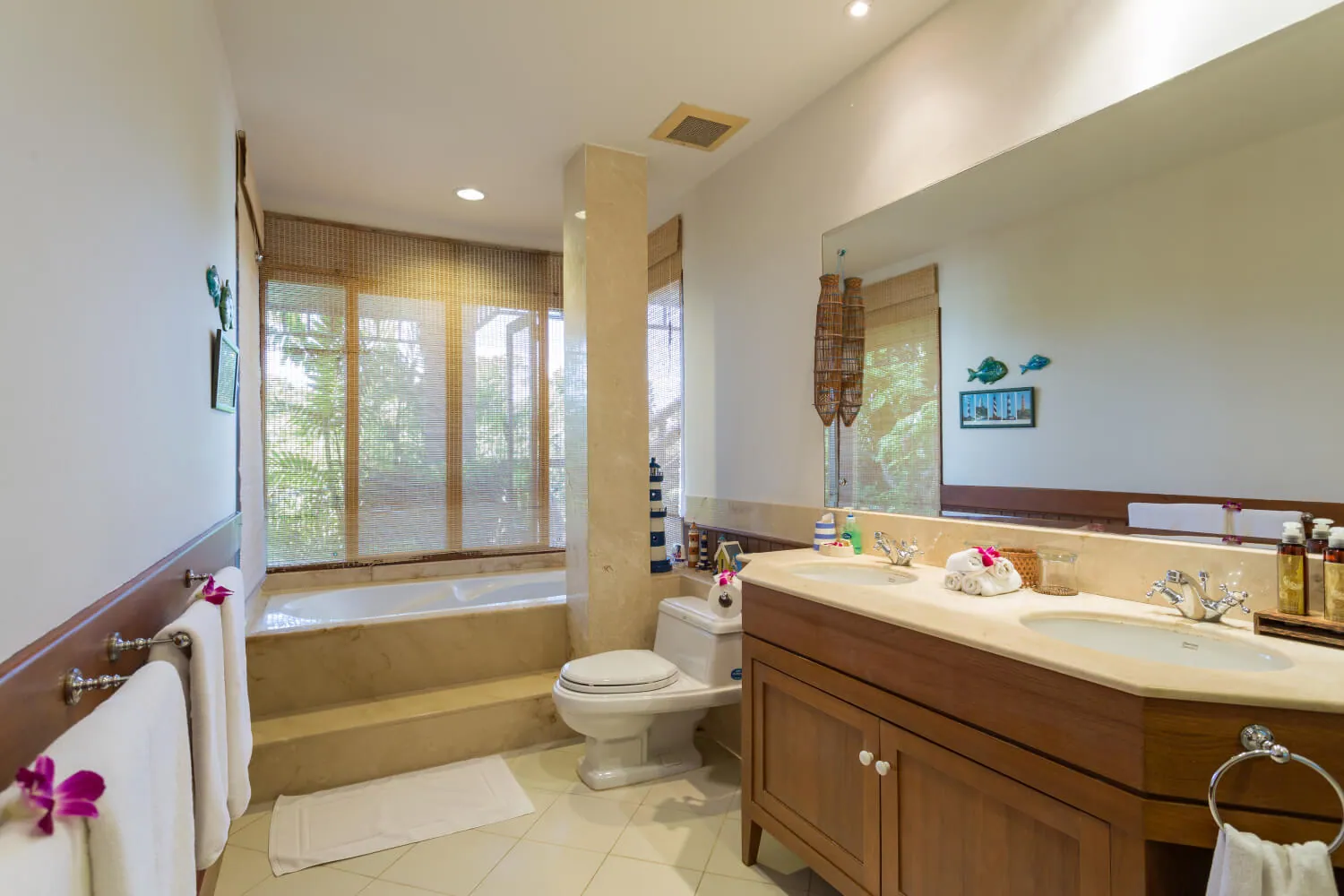 An en-suite bathroom with bath and twin vanity