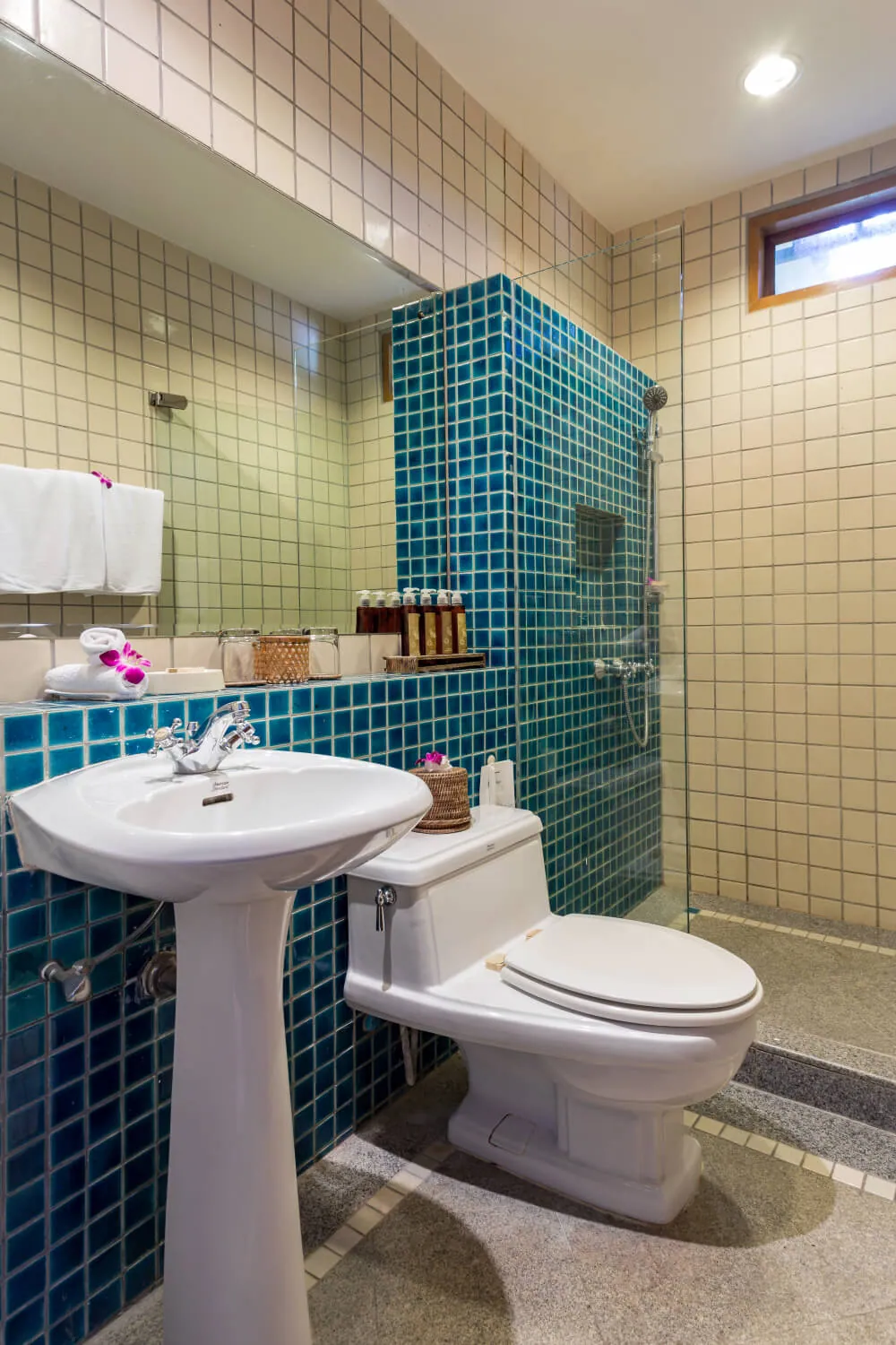 An en-suite bathroom finished in blue mosaic tile