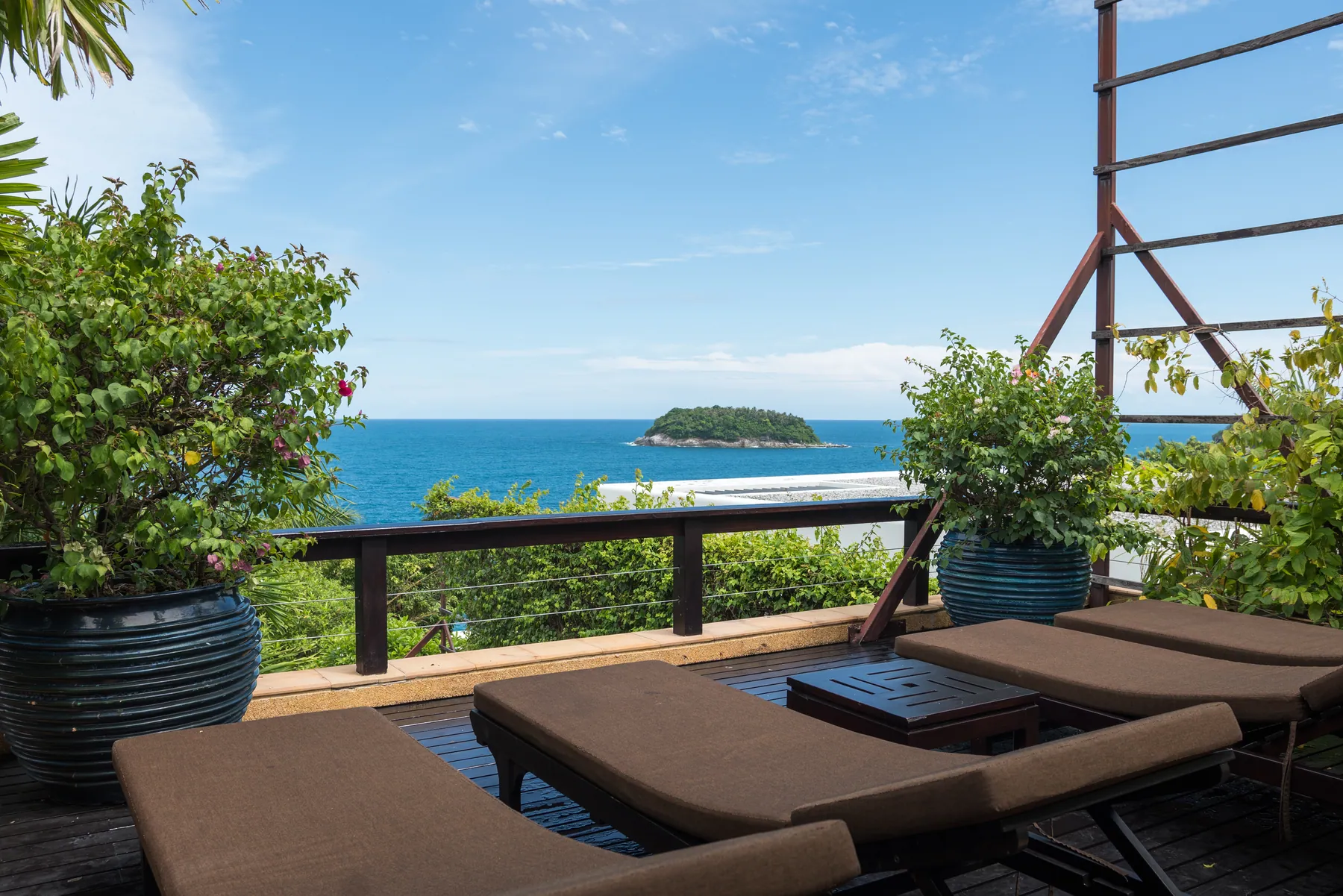 Sun loungers on the deck looking out to the islands off Kata