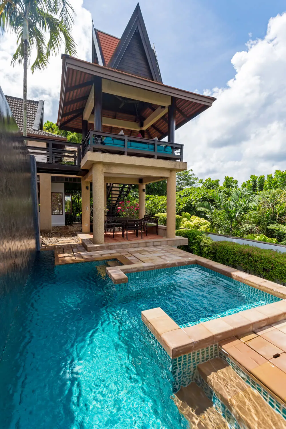 The pool cascading past the sala on the lower level