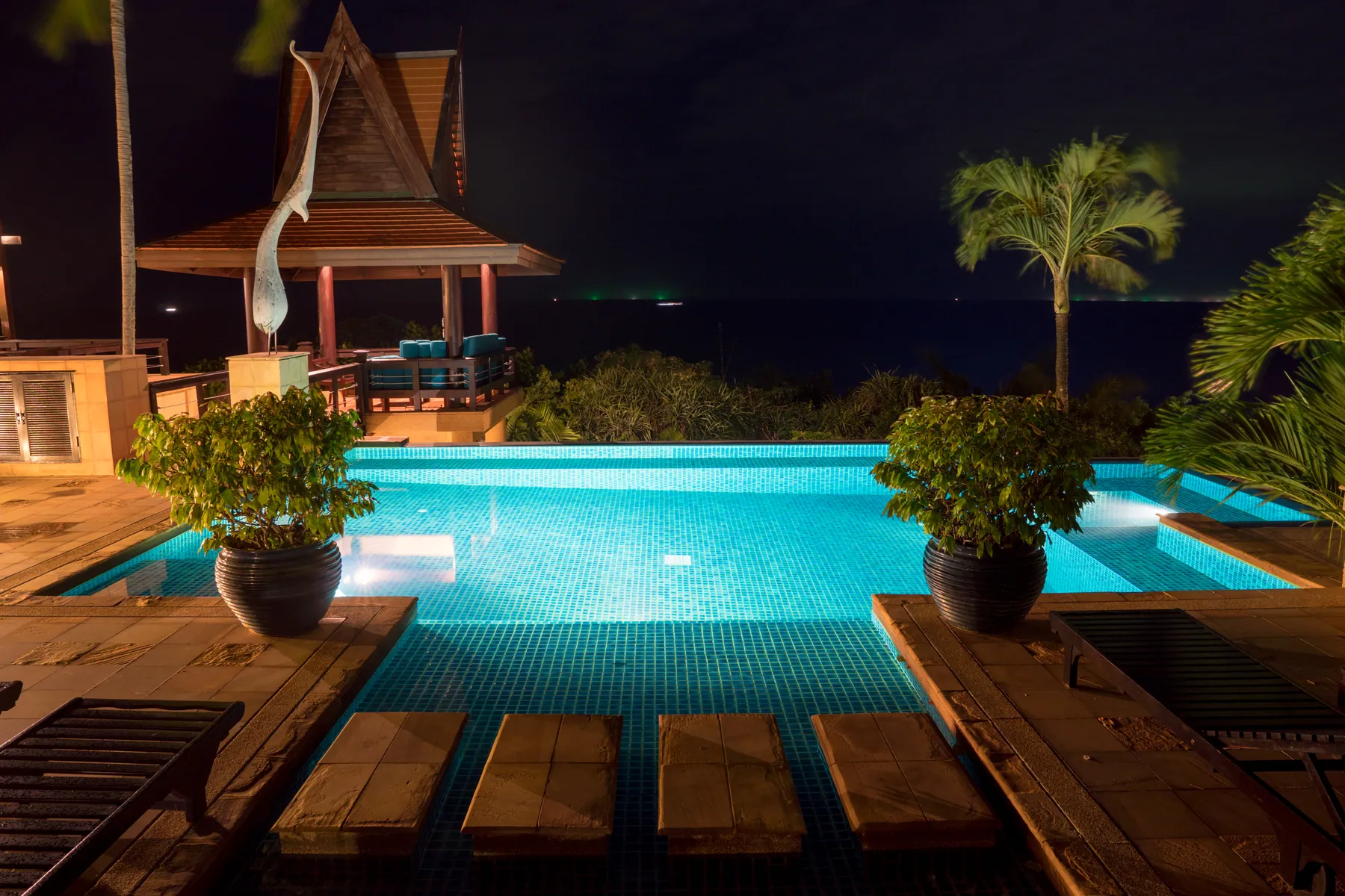 The pool deck and sala after dark
