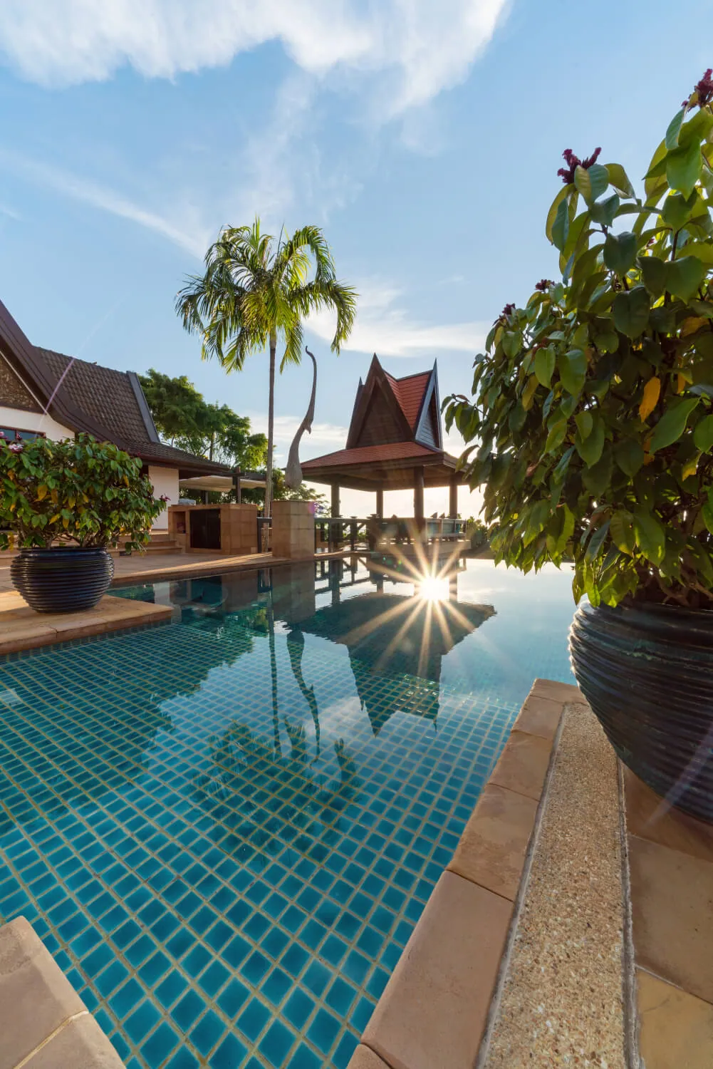 Sun breaking over the infinity edge of the pool
