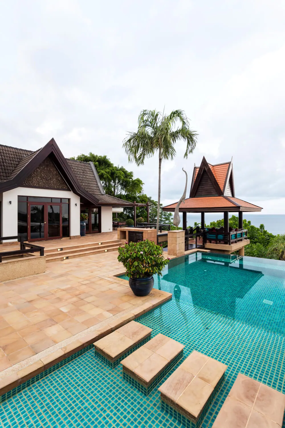 Sandstone stepping stones over the aqua pool tiles