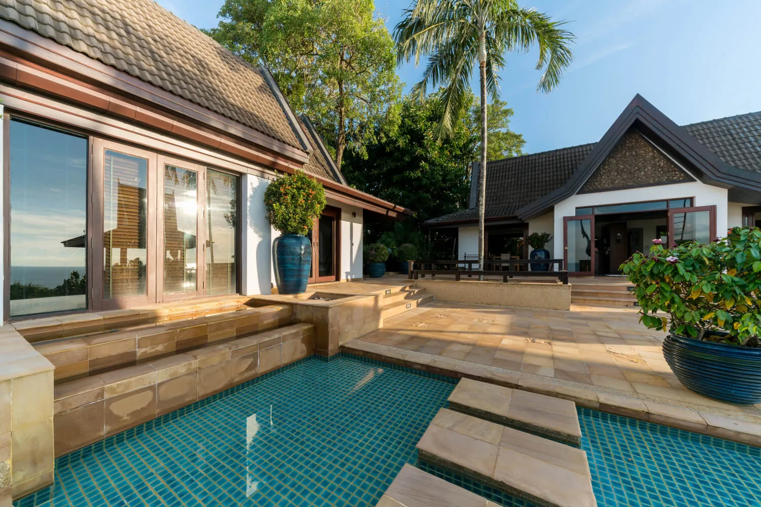 The sandstone terrace stepping down to the pool
