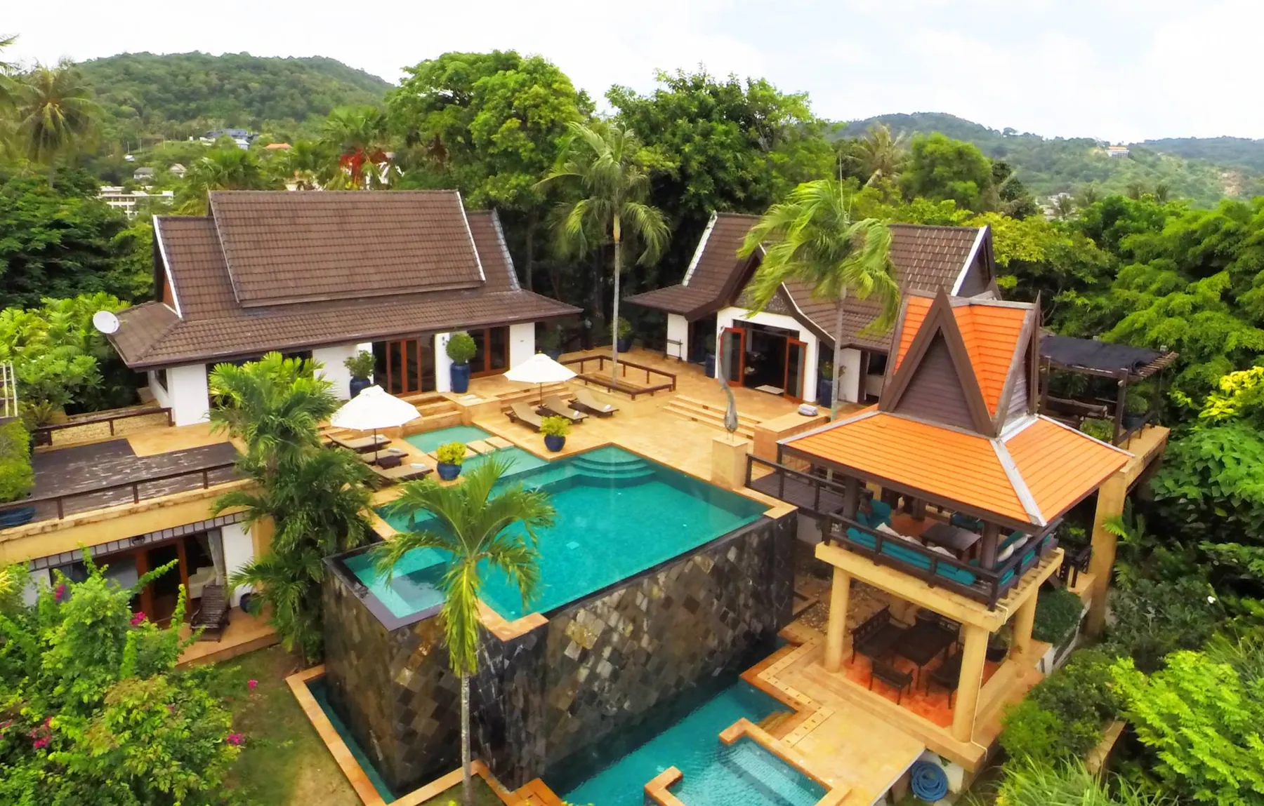 The villa and its pool terrace from above, set into the hillside